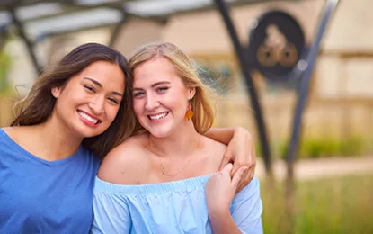 Girls leaning on one another