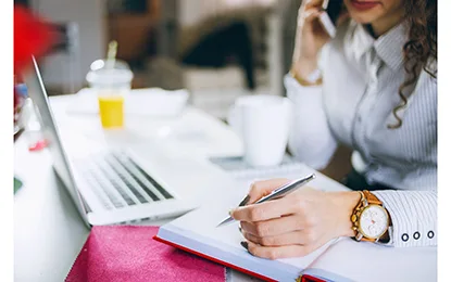 Woman with notebook and laptop