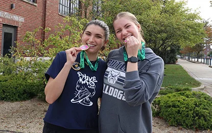 Two women holding medals