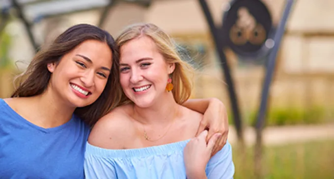 Girls leaning on one another