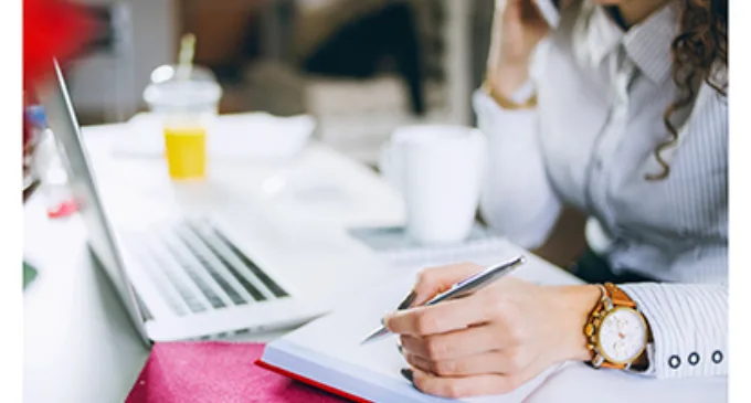 Woman with notebook and laptop