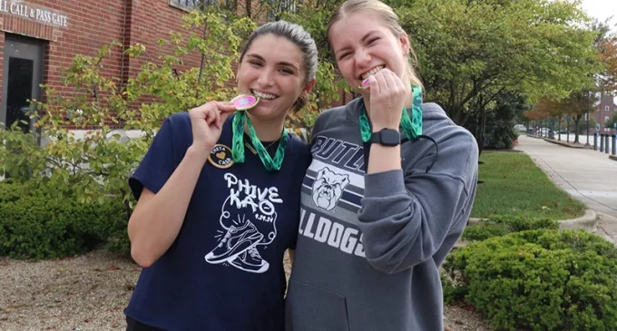 Two women holding medals